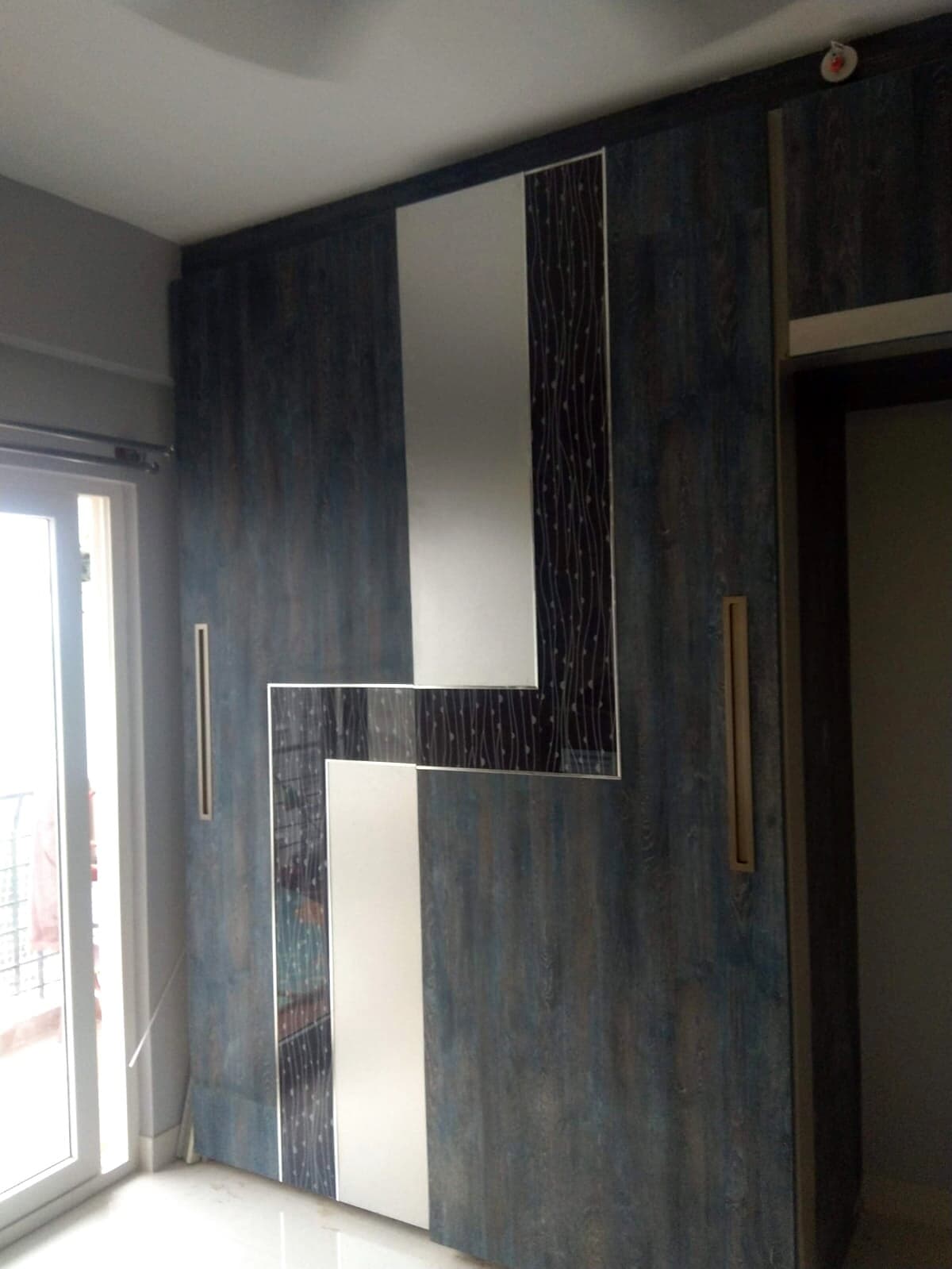 Dark Wood Sliding Wardrobe Loft from an Abya completed interior project