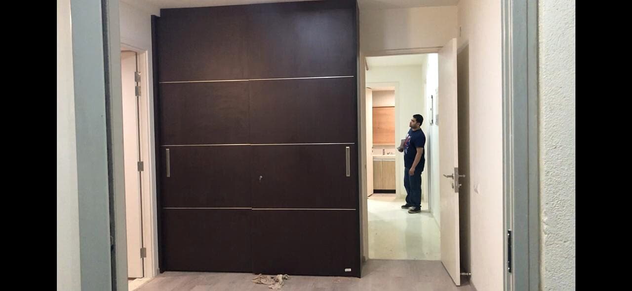 Dark Wood Sliding Wardrobe Room View from an Abya completed interior project