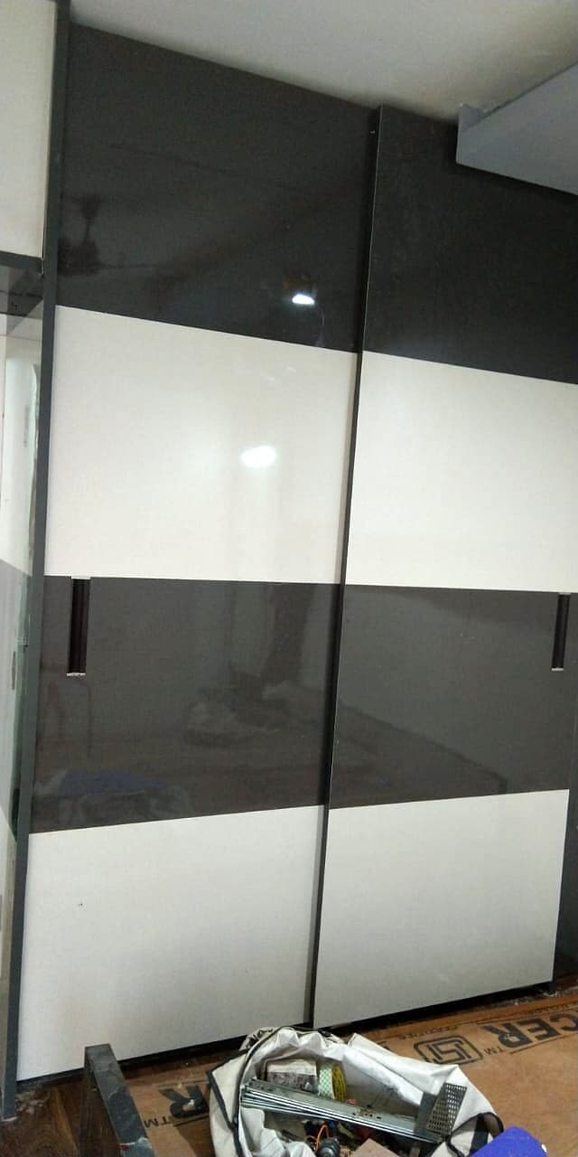 Glossy Black White Sliding Wardrobe from an Abya completed interior project