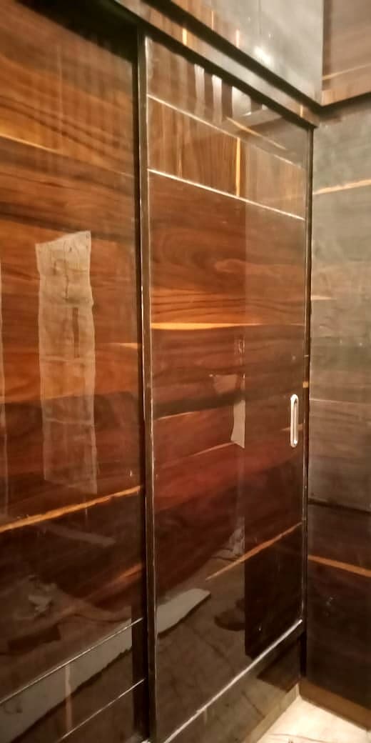 Wood Grain Sliding Wardrobe Closeup from an Abya completed interior project
