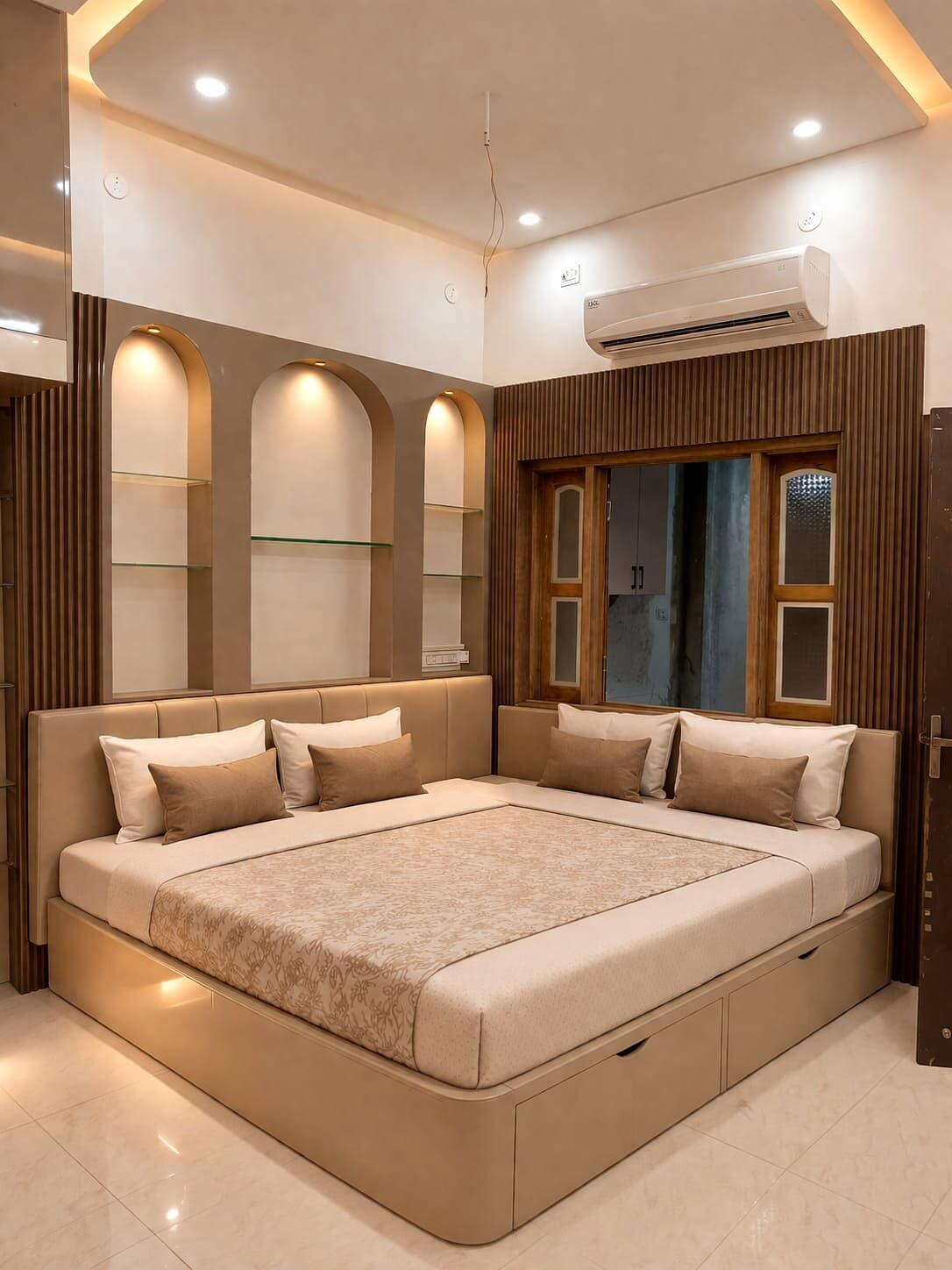 Whitefield bedroom with wooden bed wall, display niches, and warm lighting